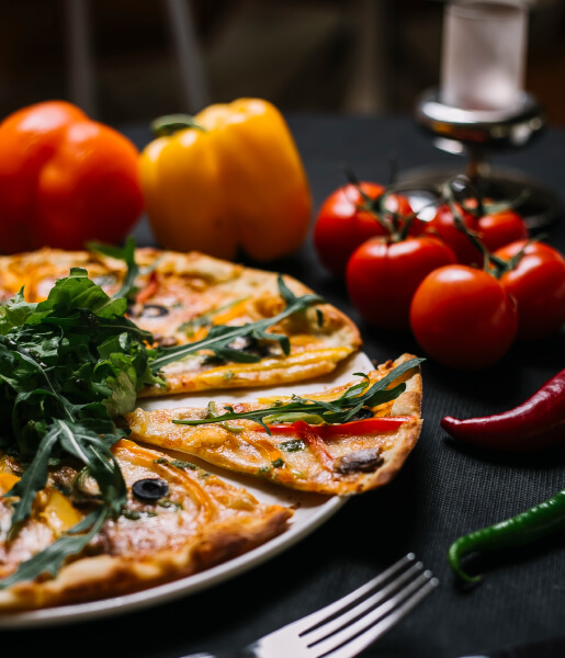 Signature Agni dish plated with fresh vegetables in a moody dining scene